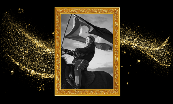 A black-and-white photo of a person on horseback holding a large flag, framed in an ornate gold frame, with shimmering gold particles in the background.